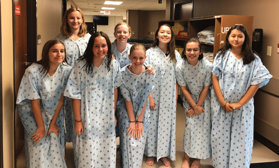 High school girls in hospital gowns