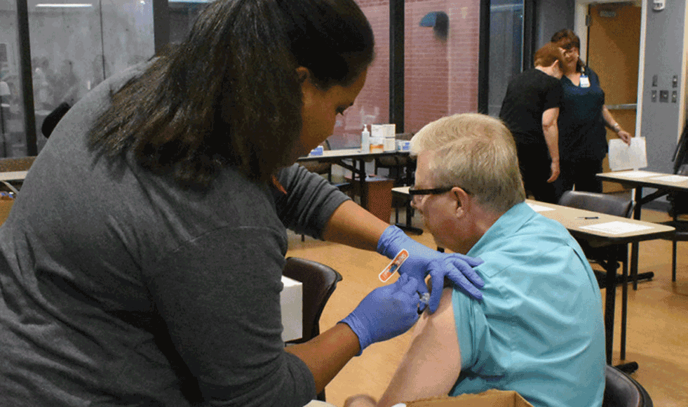 Alan Riddle, Project Manager with IT receives his yearly flu shot during our Annual Flu Vaccination and PPD Clinic.