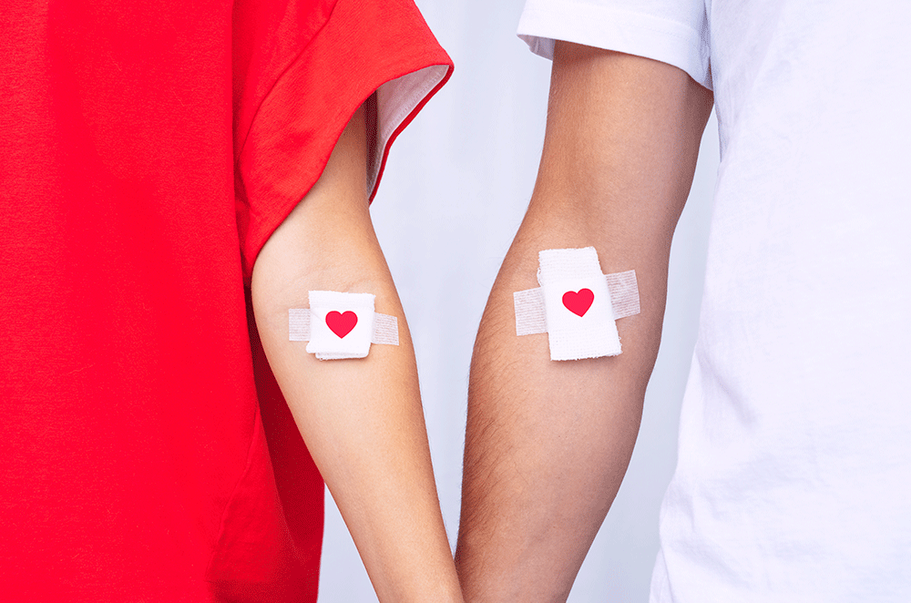 Blood donors with heart bandages after giving blood