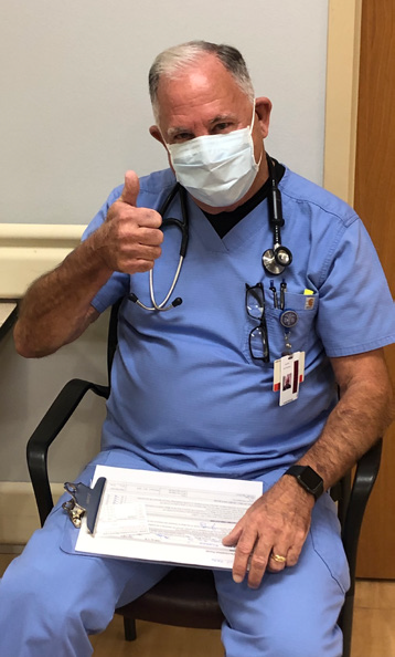 COVID vaccinated CCMH employee posing for picture with a thumbs up
