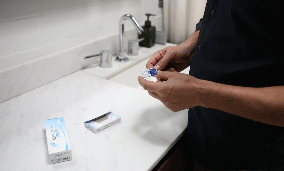 Person cleaning their contact lenses - National Contact Lens Health Week