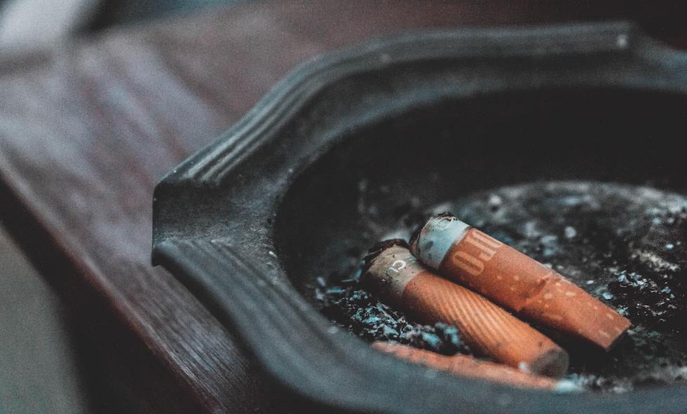 smoking and secondhand smoke from cigarettes in black ashtray can cause heart disease