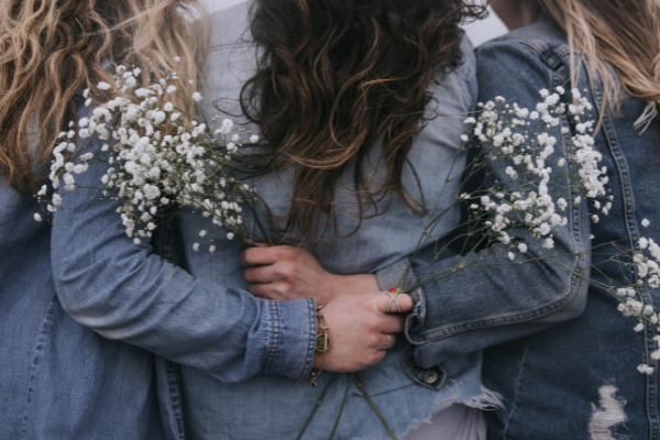 Women hugging with flowers - polycystic ovary syndrome
