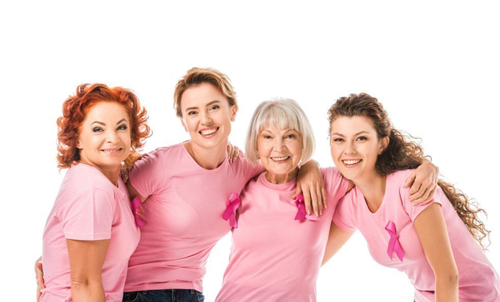 Smiling women wearing pink shirts and pink ribbon for breast cancer awareness