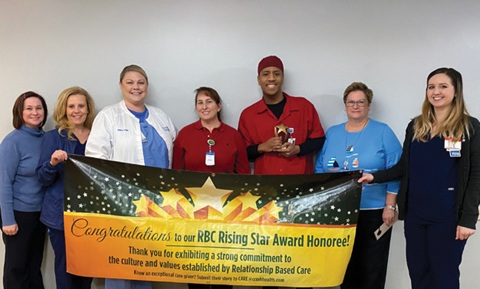 Keanu Ashmore and CCMH Staff with Rising Star Award Banner